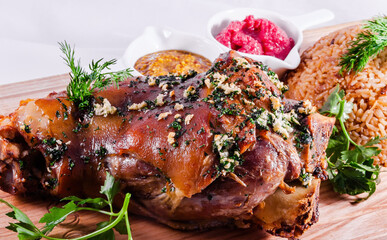 German style roasted pork hock (knuckle, shank) with rice on wooden cutting board
