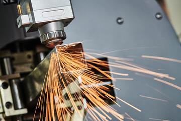 Laser cutting of metal pipe with sparks on tube laser machine - obrazy, fototapety, plakaty