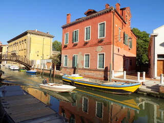 Fototapeta na wymiar Boat in Venice Italy Canal with a Reflection
