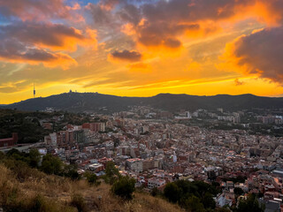Amazing landscape with dramatic sky over the city with aerial view. Mountain on the horizon in the background at sunset or sunrise.