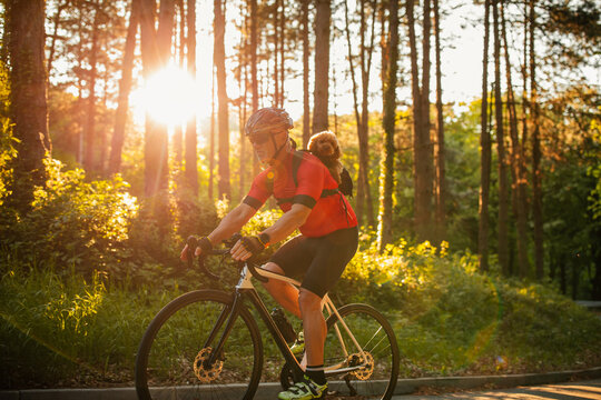 Male bicyclist on tour with his dog in forest