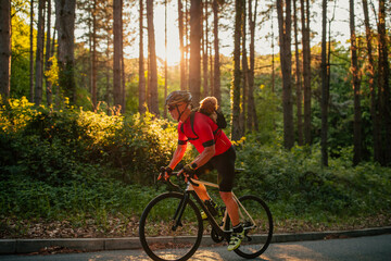 Man and dog in backpack on bike tour in forest