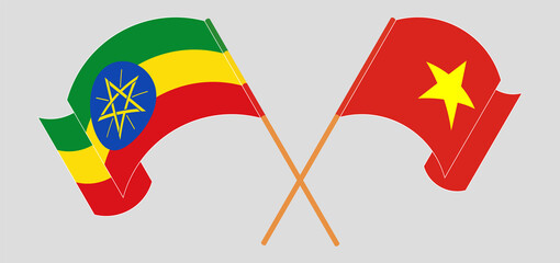 Crossed and waving flags of Ethiopia and Vietnam