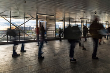 pedestrian motion along transparent bridge to entrance of subway
