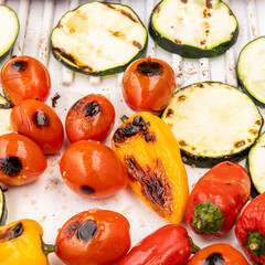 Grilled cherry tomatoes, small red and yellow bell peppers, sliced zucchini with salt