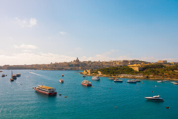 Fototapeta na wymiar Valletta, Malta. Aerial shot of Valetta in Malta. Beautiful sunny day, the mediterranean sea, harbour, boats.