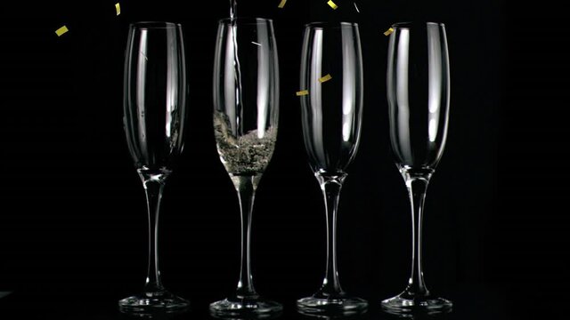 Animation of champagne glasses and champagne pouring, with gold confetti falling on black background