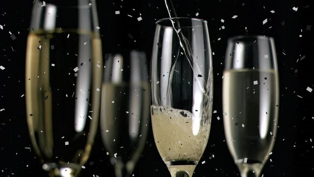 Animation of champagne glasses and champagne pouring, with confetti falling on black background