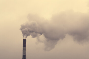 Smoking chimney of a coal power plant. Dramatic smoke. Air pollution. Release of harmful substances into the atmosphere