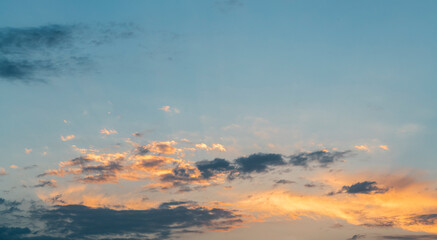 Amazing summer sky with beautiful orange clouds after sunset. Sky background.