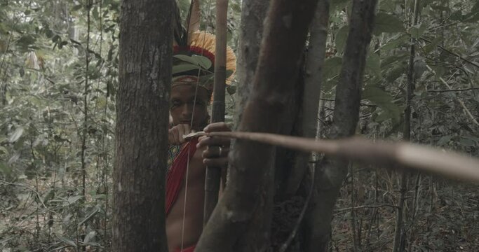 Indian from the Patax&oacute; tribe using a bow and arrow. Brazilian Indian. 4K.