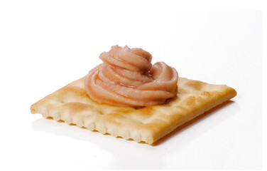 Cracker soda with salmon fish pate isolated on white background.