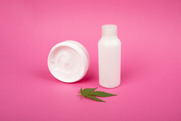 Obraz na płótnie Canvas body care, anti-aging skin care cosmetics with marijuana extract on a pink background