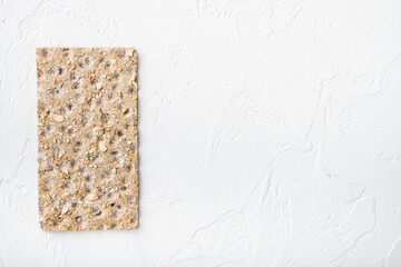 Thin rye crispy cracker, on white stone table background, top view flat lay, with copy space for text