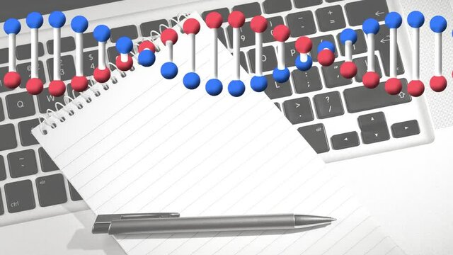 Animation of dna strand spinning over laptop, notebook and pen on desk