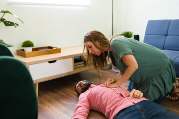 Girlfriend giving first aid emergency CPR