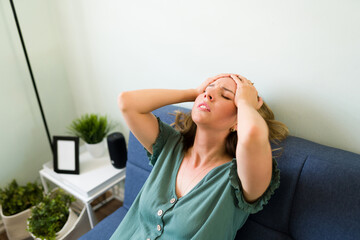 Woman rubbing her head to relieve the pain