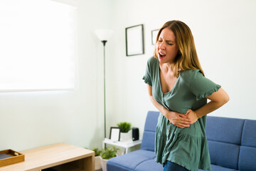 Woman screaming from the pain in her stomach
