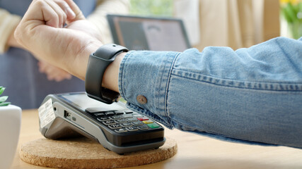 Close-up hand asia woman people work in small sme coffee café shop store owner use cashless wifi paywave nfc scan app smart pos reader sale in take out food drink order in urban city life contactless.