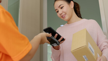 Asia young smile happy woman people receive parcel postal from e-commerce online shop store use...