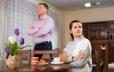 Man and woman are offended at each other because of the misunderstanding in his home. High quality...