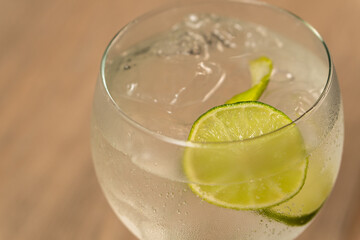 Close-up view of gin and tonic cocktail with lemon slice