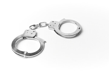 Handcuffs chrome plated isolated on white background, law and order concept used by the authority to arrest criminals