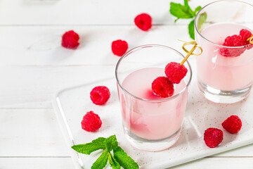 Raspberry Vodka Pink Lemonade Cocktail with Fresh Raspberry Background. Selective focus.