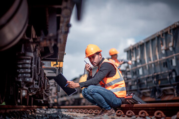 Engineer under inspection and checking construction process railway switch and checking work on...