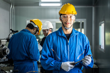 Portrait of Asian Mechanical worker smile, look at camera in factory.