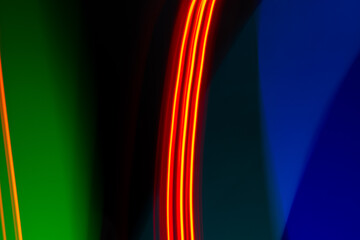 neon light motion on black. colorful abstract light background. shining light for decorating design as background and overlay to beautify a creative project.