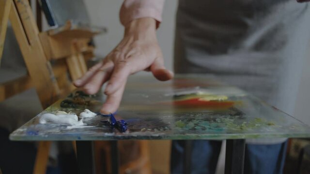 Close-up, Artist's Hand Draws Oil Paints on Glass