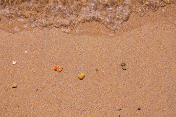 Soft wave of the sea on the sandy beach.