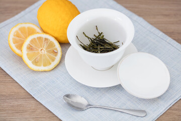 Tureen with tea leaves and lemon