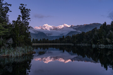Aoraki / Mount Cook and Mount Tasman seen from Lake Matheson during blue hour