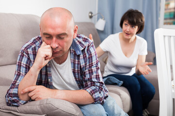 Sad family having difficulties in the living room at home. High quality photo