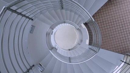 Ascending Shot Of a Drone Flying In The Middle Of Spiral Staircase - aerial shot