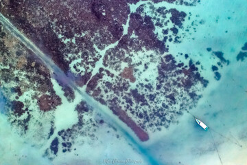 Coastline in Southern Thailand aerial drone uav high altitude landscape over the sea and land and mountains with sunny weather and clouds with turquoise water and copy space