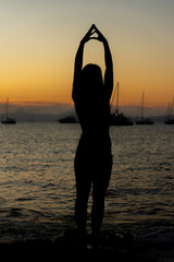 Woman practicing yoga on the beaches of Formentera in Spain