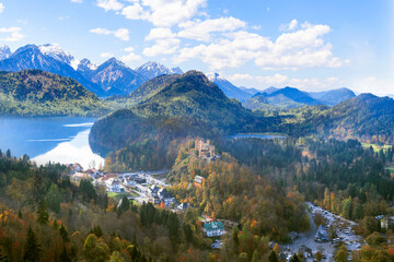 Fototapeta na wymiar Landscape with Hohenschwangau Castle, Bavaria, Germany. Beautiful panorama of mountain lakes. Scenery of Alpine nature in autumn. Aerial scenic view of village in Alps.