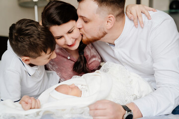 the first day of the newborn at home. Happy family with a toddler in the bedroom