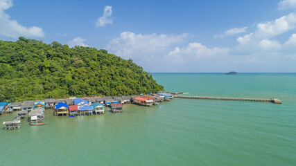 Fototapeta na wymiar Fishing Village in Chumphon, Thailand. with clouds and mountains in the background and copy space