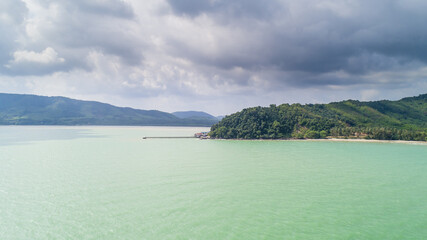 Fishing Village in Chumphon, Thailand. with clouds and mountains in the background and copy space