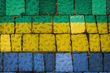 National flag of Gabon on stone  wall background. Flag  banner on  stone texture background.