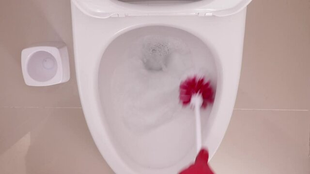 lavado de WC blanco con cepillo rojo