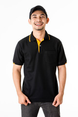 Confident Asian delivery man smiles and looks at camera with smile. Studio medium shot portrait of courier guy in black uniform on isolated white background. E-commerce business concept.