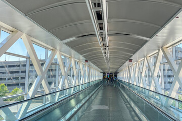 Walking bridge between terminals at Boston Logan International Airport in USA. - obrazy, fototapety, plakaty