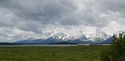 Spring in Grand Teton National Park: Gray Skies over Jackson Lake, Donoho Point Island and Grand Teton, Mount Saint John, Mount Woodring & Mount Moran of the Teton Range Seen From Jackson Lake Lodge