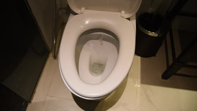 close up dirty flush toilet in home.