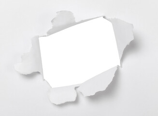 Ripped white paper. Torn hole in white paper sheet.